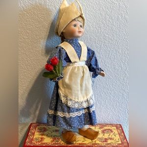 Porcelain Dutch Girl with wooden shoes and stand.